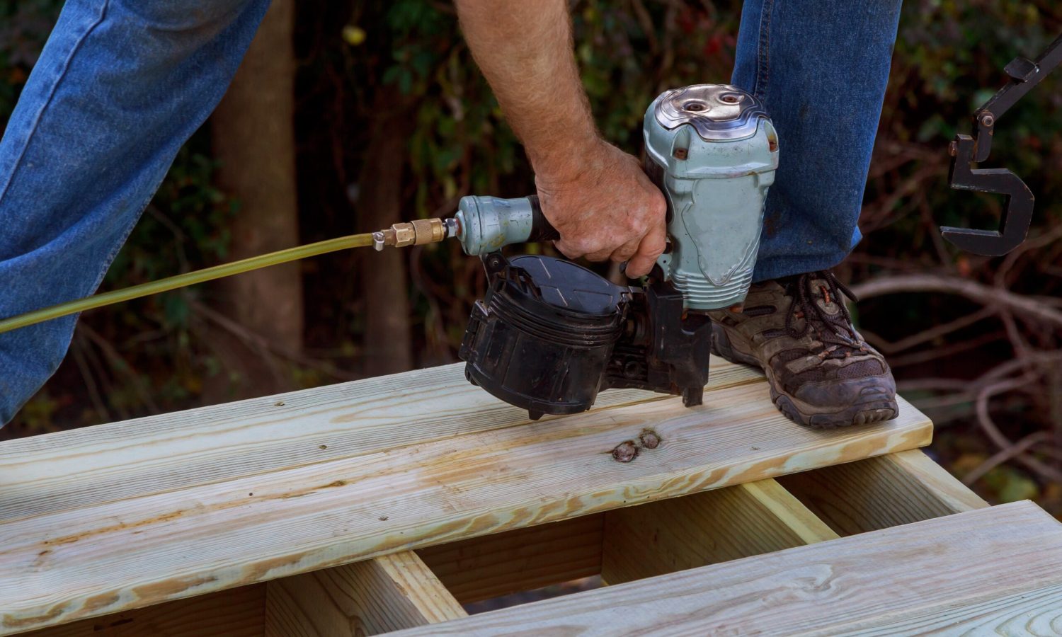 Close up of exterior timber decking building a backyard deck with composite deck boards