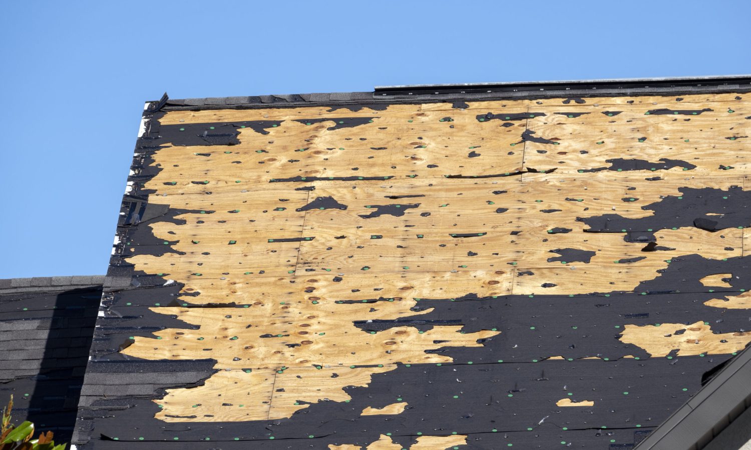 Hurricane Ian destroyed house roof in Florida residential area. Natural disaster and its consequences.