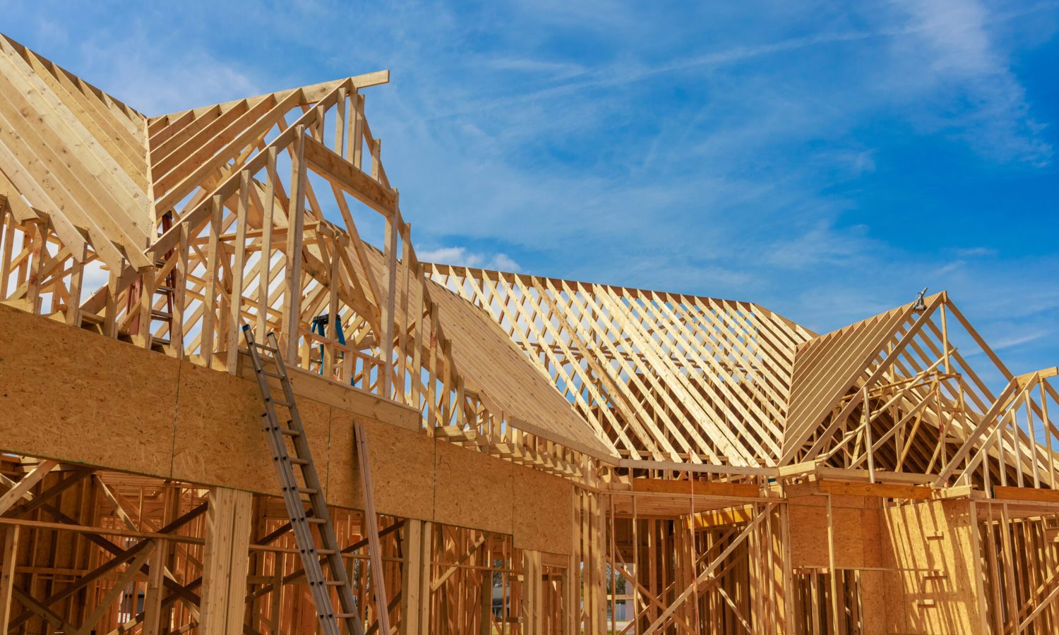 The framing beams of a house in construction.